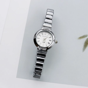 Close-up of a silver quartz watch featuring a Roman numeral dial and rhinestone bezel