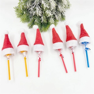 Detailed view of six mini Christmas lollipop hats on a festive white background