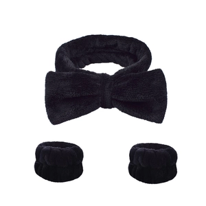 Three-piece set featuring a black plush bow headband and matching wrist washbands