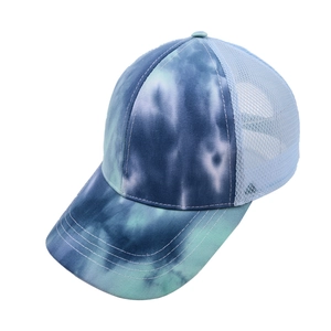 Detail of blue tie-dye baseball cap featuring breathable mesh back and multi-stitch brim