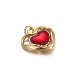 Detail view of a minimalist 18K gold plated heart pendant with a red center stone