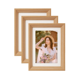 Three-piece light wood picture frame set with white matting displayed on white background