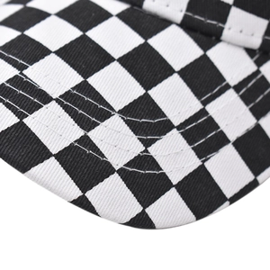 Close-up of black and white checkered baseball cap showing detailed reinforced stitching
