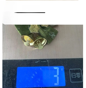Weight measurement of green linen Christmas bow with golden bells for tree decoration