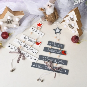 Set of two wooden Christmas tree ornaments with bells and red bird details