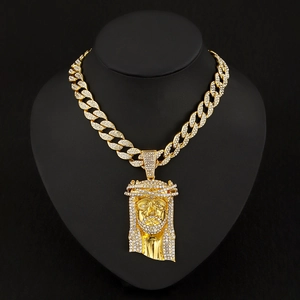 Detailed view of hip hop Jesus pendant with rhinestones on a gold Cuban link chain