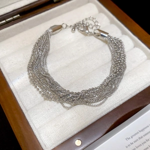 Detail of silver multi-layered beaded chain bracelet with adjustable lobster clasp