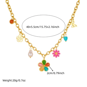 Gold chain necklace with colorful flower, heart, and butterfly charms in a flat lay view