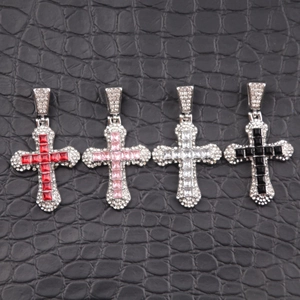 Close-up of hip hop cross pendants with vibrant cubic zirconia in four colors on leather