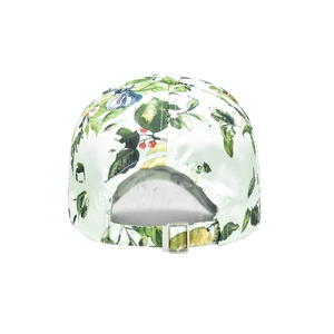 Detail of adjustable silver buckle on back of baseball cap with floral lemon print