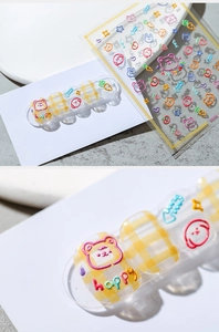 Detail of 3D embossed nail stickers featuring cute cartoon bears and fruits texture