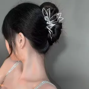 Detailed view of silver angel wings hair claw clip with shimmering rhinestones on hair