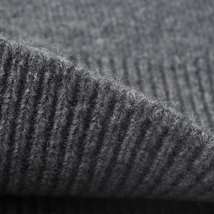Detailed macro view of gray ribbed wool knit fabric on thick winter beanie hat