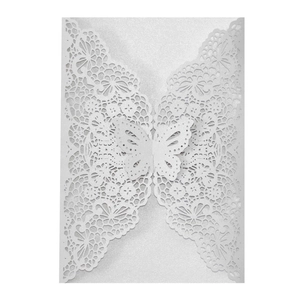 Detailed laser-cut white butterfly and floral patterns on pearlescent paper invitation