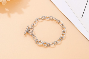Detailed shot of silver infinity charm bracelet with twisted chain and toggle clasp