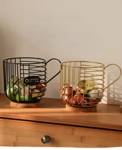Detail of metal coffee pod holder baskets with wooden base in black and gold finish
