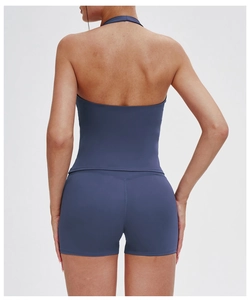 Rear view detail of V-neck halter sports vest with open back and tight fit yoga shorts