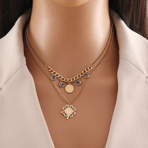 Gold double layer necklace featuring evil eye bead and hollow four-leaf clover pendant