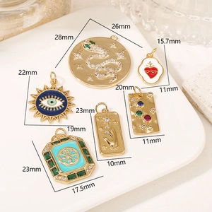 Detailed size chart for 14K gold filled charms featuring snake and evil eye motifs