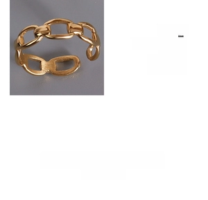 Detail of adjustable gold-plated chain link ring featuring a polished knuckle design