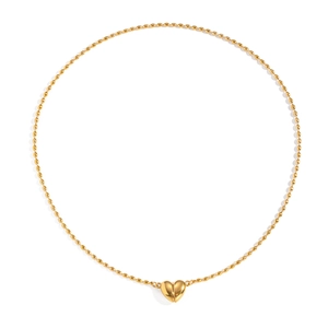 Détail macro d'un pendentif cœur en acier inoxydable plaqué or 18K sur chaîne à perles