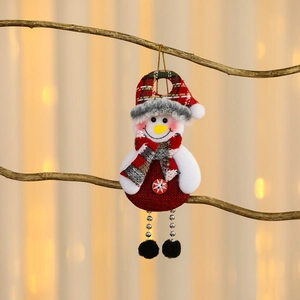 Hanging Christmas snowman ornament with plaid hat and swinging chain legs on branch