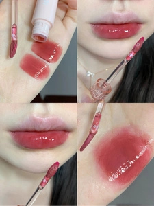 Watery mirror lip glaze detail showing texture, applicator and berry red lip swatches