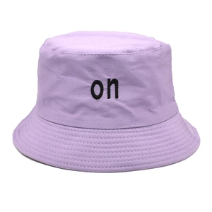 Detailed view of the black letter embroidery on a light purple cotton bucket hat