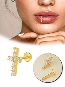 Detailed view of golden cross labret piercing with white zircon and model wearing effect