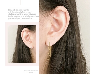 Detail showing gold and silver S925 long spiral wave tassel earrings in a side-by-side view