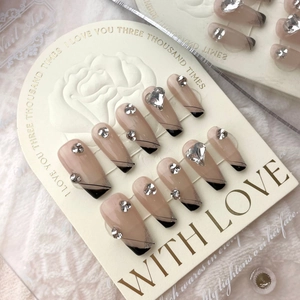 Handmade black French press-on nails with sparkling glitter and heart-shaped crystals