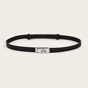 Detail of slim black leather belt featuring a classic silver metal swivel lock buckle