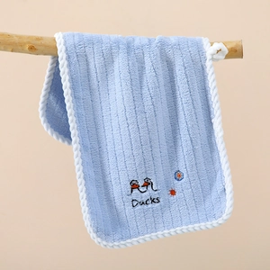 Detail of soft blue microfiber towel featuring cute duck embroidery and striped texture