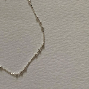 Minimalist 925 sterling silver beaded bracelet with round and flat beads in elegant arc