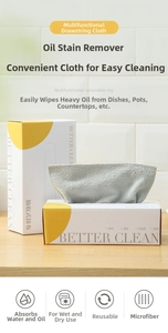 Close-up of microfiber kitchen cleaning cloths in a dispenser box on wooden surface