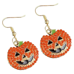 Detail of Halloween pumpkin earrings featuring vibrant orange rhinestones and gold hooks