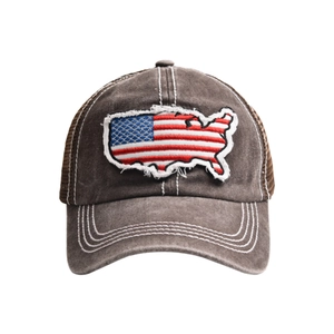 Macro detail of vintage distressed American flag patch on a mesh trucker baseball cap