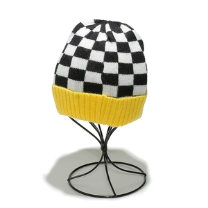 Winter checkered knit beanie with black and white pattern and yellow ribbed cuff detail