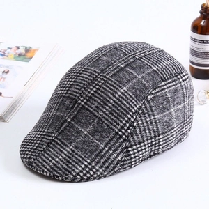 Close-up of classic black and white checkered flat cap with premium fabric texture