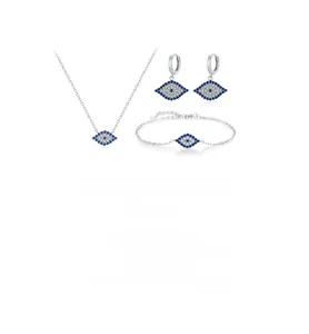 Macro view of S925 silver evil eye jewelry set featuring blue stones on a white background