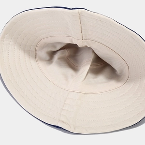 Detail view of the breathable cotton lining and reinforced stitching on reversible sun hat