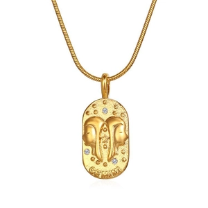 Detail of a gold Gemini zodiac oval pendant necklace with zircons on a snake chain