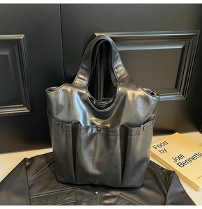 Detail of the black PU leather tote bag with multi-pockets and soft vintage texture