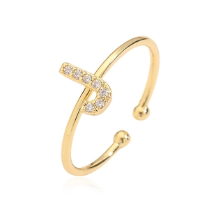 Macro shot of gold letter P open ring featuring sparkling cubic zirconia stones