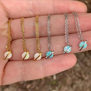 Saturn opal planet necklaces in gold and silver finishes with white and blue pendants