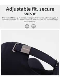 Close-up of navy blue baseball cap with adjustable metal buckle and brand engraving