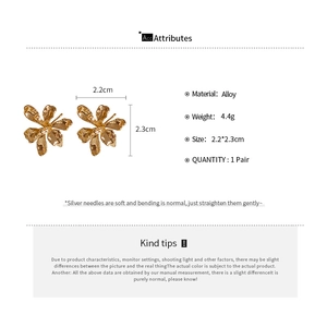 Detail view of 3D gold flower stud earrings with alloy material and silver needle
