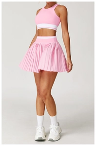 Pink seamless yoga tank top with white stripe detail and matching pleated skirt