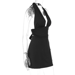 Side view of black halter backless mini dress with ruched waist on transparent mannequin
