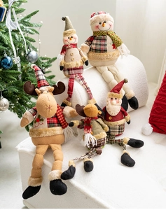 Close-up of festive fabric dolls with red plaid patterns in a cozy Christmas setting